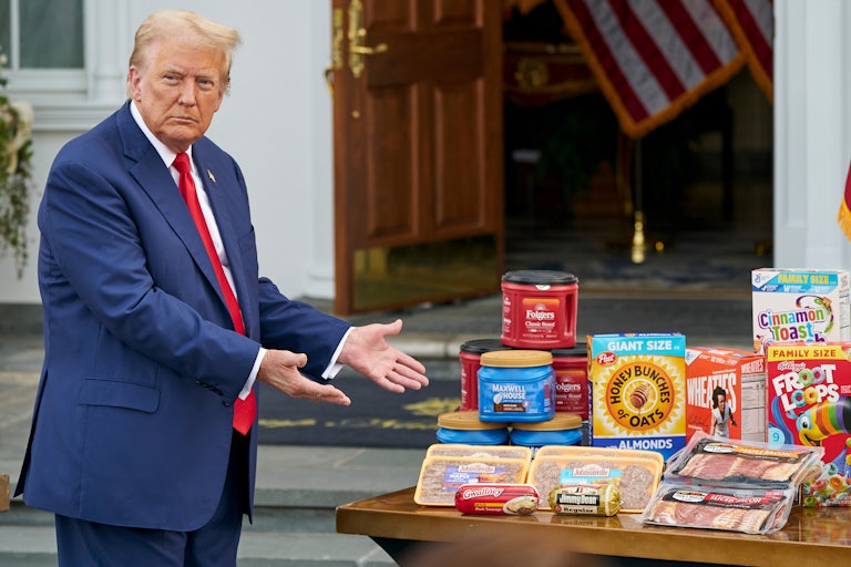 Donald Trump poses with groceries during a campaign speech at his Bedminster, New Jersey, club about rising food costs