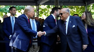 Donald Trump and Rudy Giuliani shake hands at a 9/11 memorial service