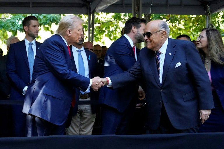 Donald Trump and Rudy Giuliani shake hands at a 9/11 memorial service