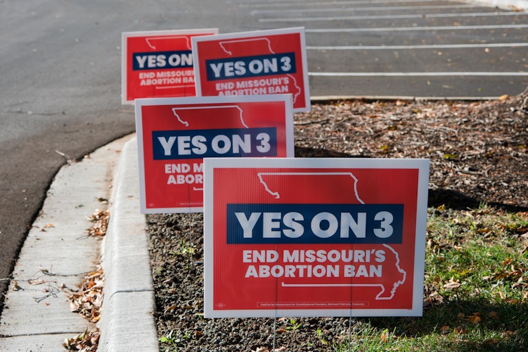 Campaign signs in Missouri encourage people to vote to overturn the state's ban on abortion
