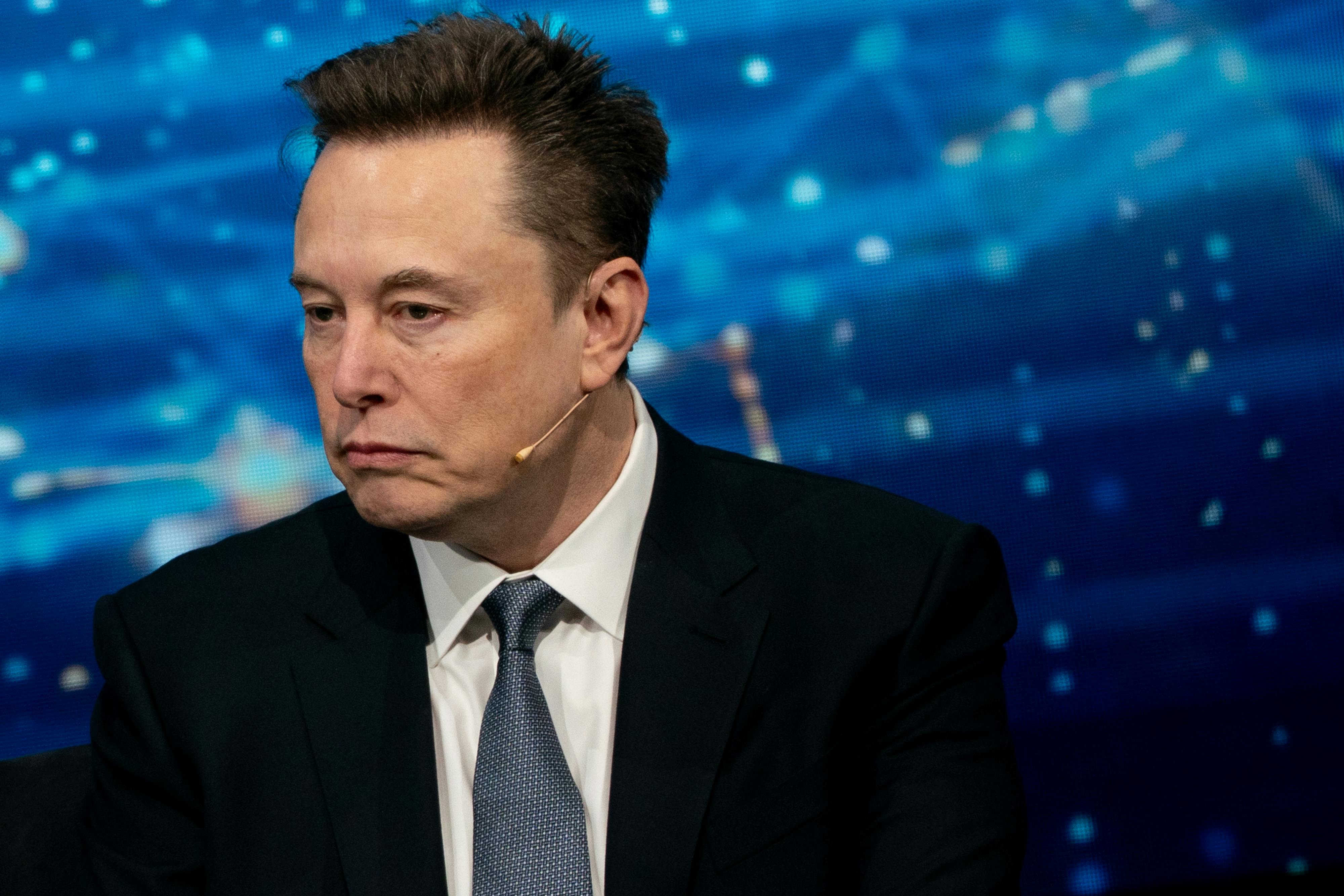 Elon Musk listens to a phone call at a White House dinner. 
