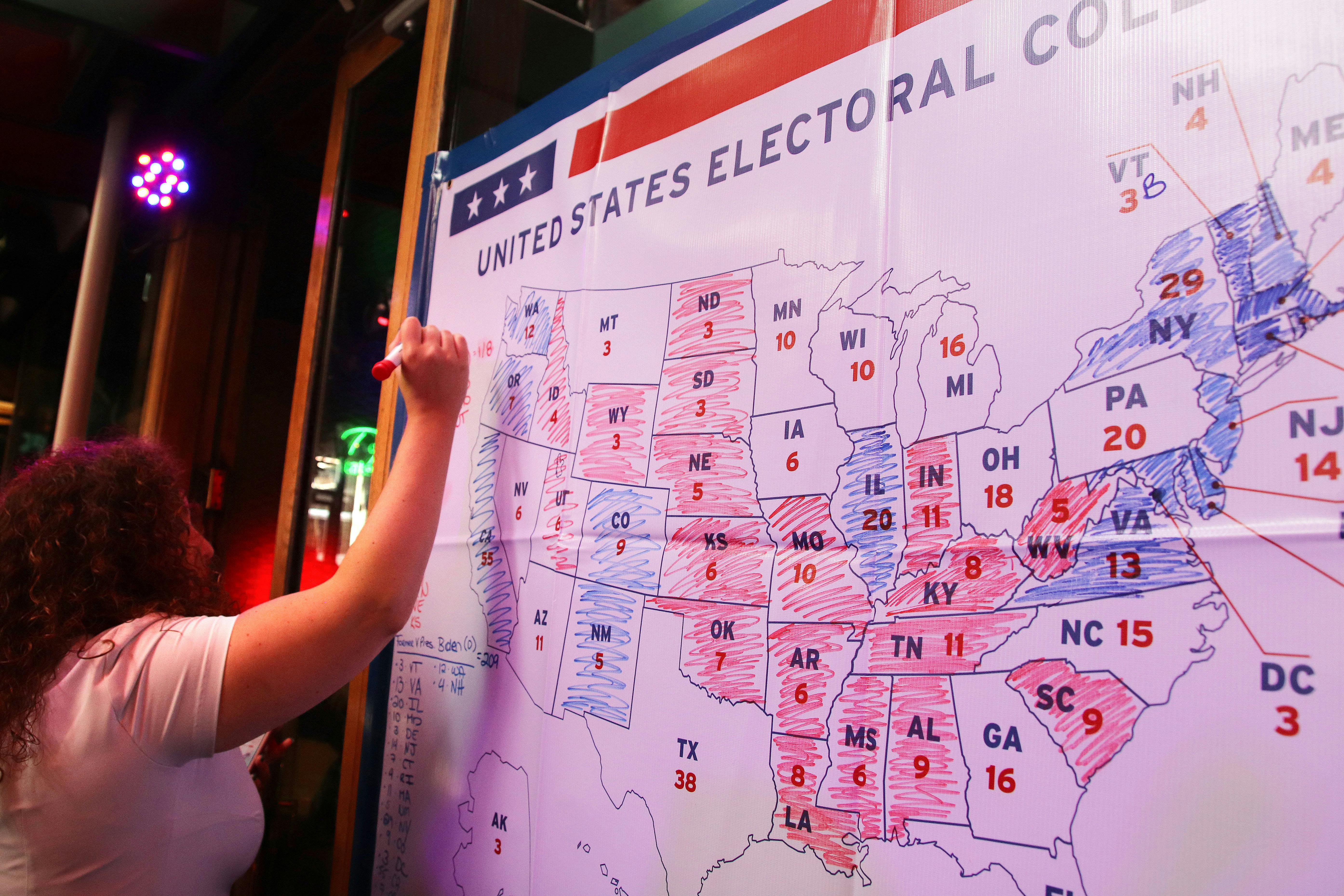 A woman prepares to color another state on the electoral college map.