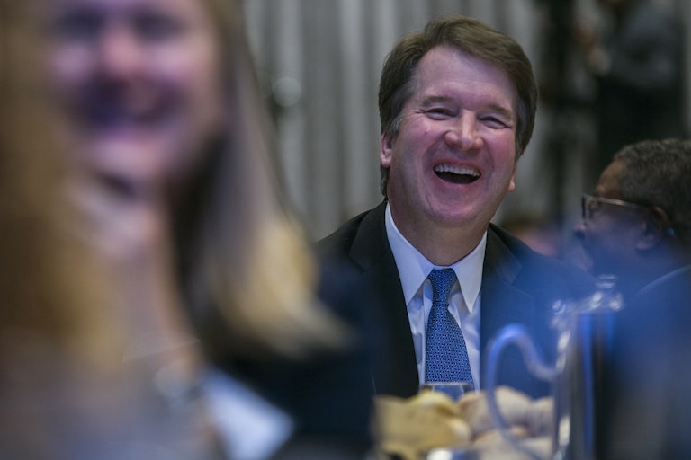 A smiling Brett Kavanaugh laughs loudly at a dinner event in Washington, D.C.