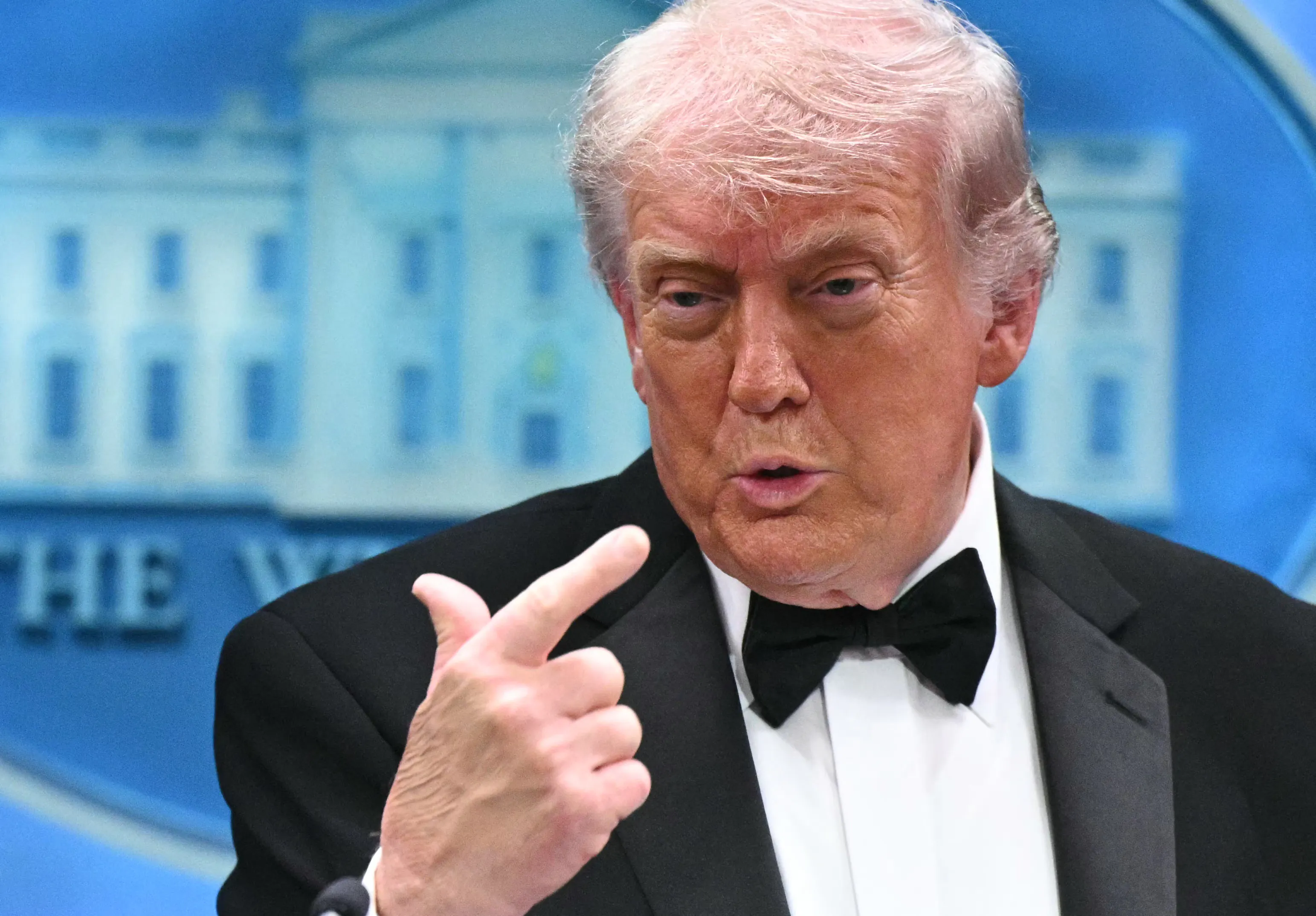 President Donald Trump points to himself while speaking in the White House briefing room