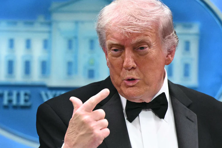 President Donald Trump points to himself while speaking in the White House briefing room