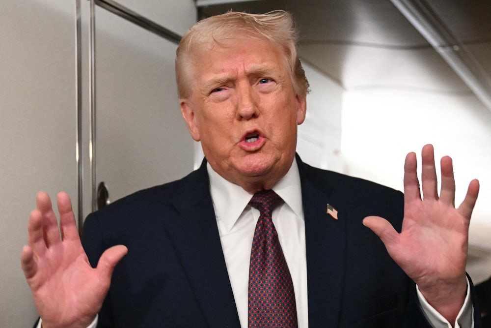 Donald Trump speaks while making pushing motion with his hands