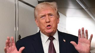 Donald Trump speaks while making pushing motion with his hands