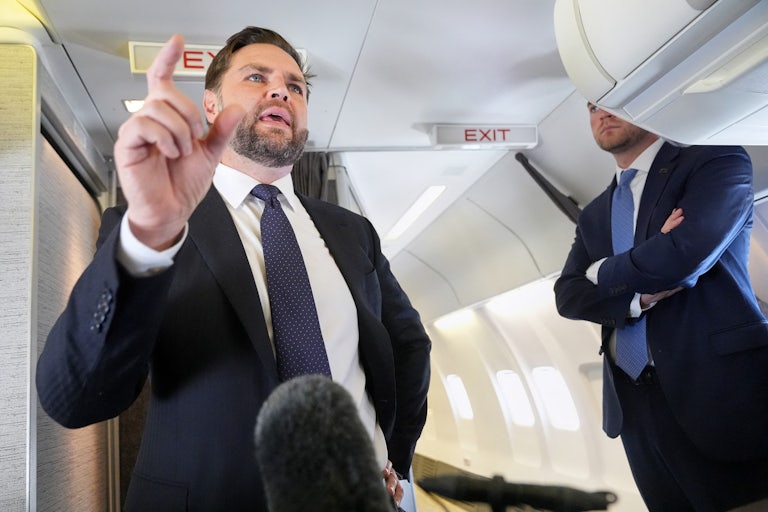 Vice President JD Vance gestures while speaking to reporters on Air Force Two