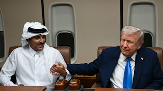 Donald Trump and Qatar’s Emir Sheikh Tamim bin Hamad Al-Thani hold hands aboard Air Force One.