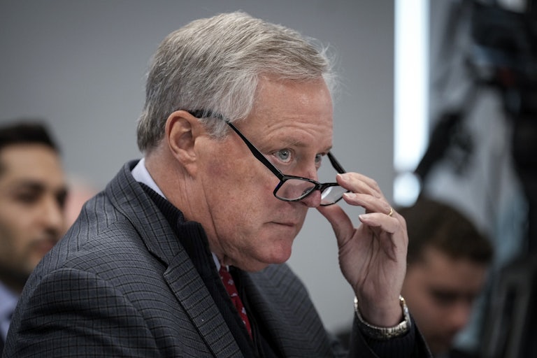 Former Trump White House chief of staff Mark Meadows lowers his glasses with his hand