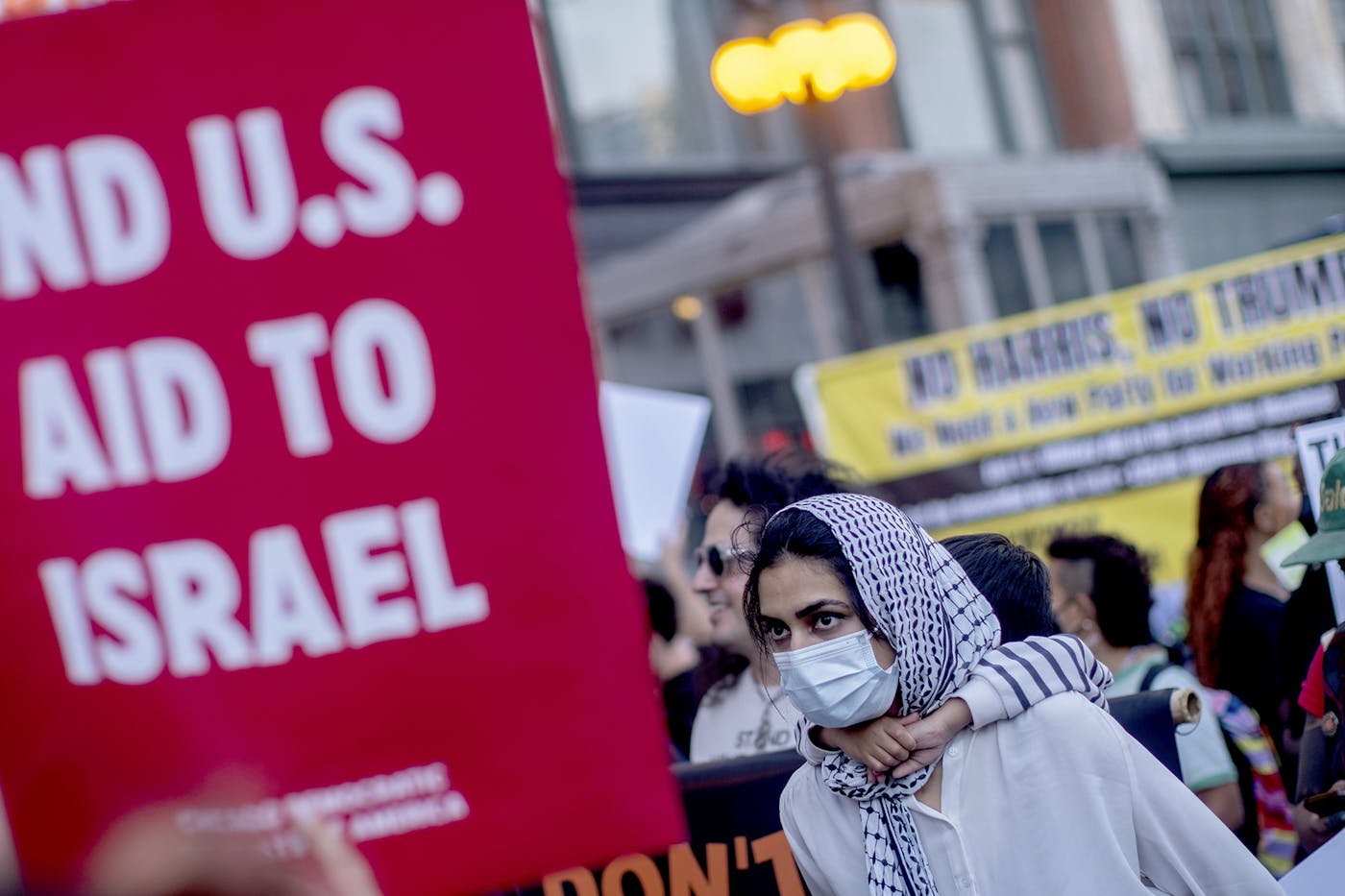 A pro Palestinian demonstrator carrying a child on her back outside the Democratic National Convention. 