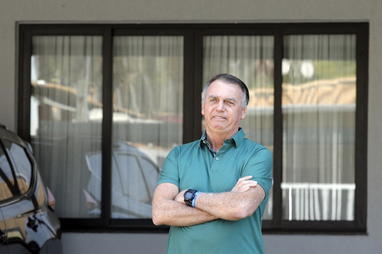 Former Brazilian leader Jair Bolsonaro is questioned by reporters.