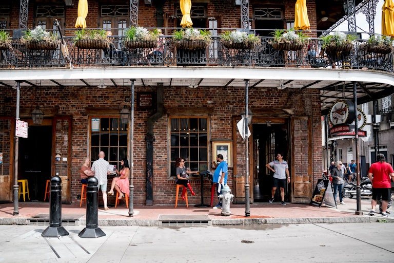 People outside a bar and restaurant on Bourbon Street, New Orleans