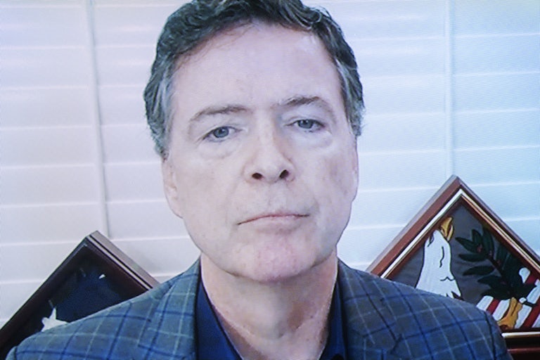 Former FBI Director James Comey appears on a screen.