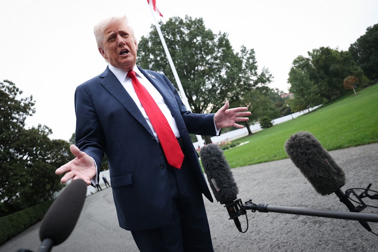 Donald Trump speaks to reporters outside the White House.