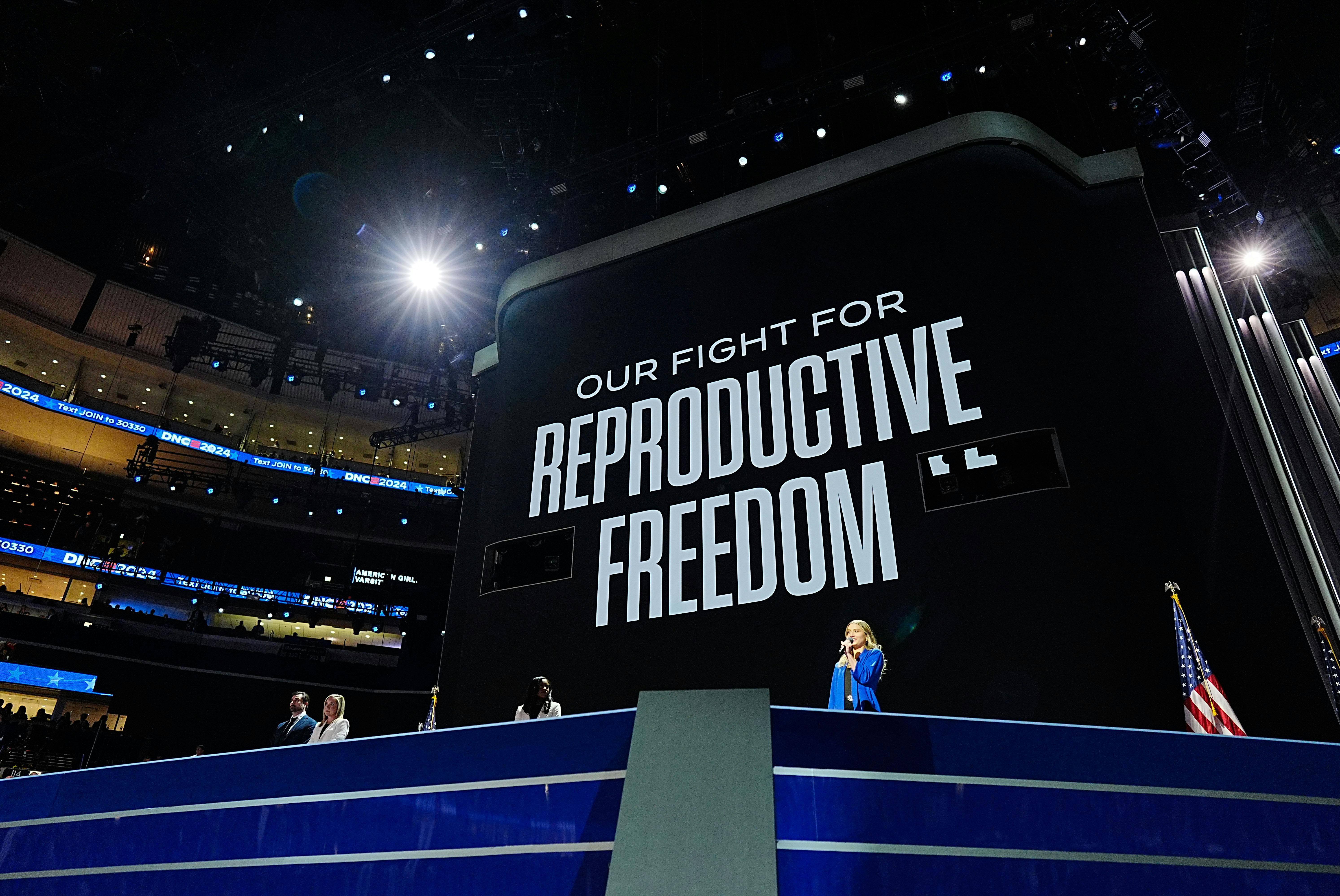 Women from states with abortion restrictions speak during the first day of the Democratic National Convention in Chicago, Illinois, under a sign reading "Our Fight for Reproductive Freedom". 