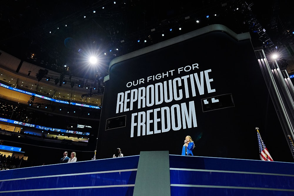 Women from states with abortion restrictions speak during the first day of the Democratic National Convention in Chicago, Illinois, under a sign reading "Our Fight for Reproductive Freedom".
