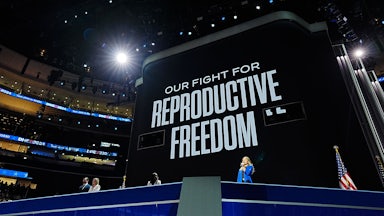 Women from states with abortion restrictions speak during the first day of the Democratic National Convention in Chicago, Illinois, under a sign reading "Our Fight for Reproductive Freedom".