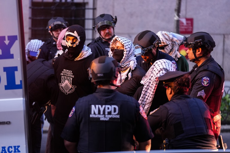NYPD officers arrest people wearing masks and keffiyehs after a protest on Columbia University's campus