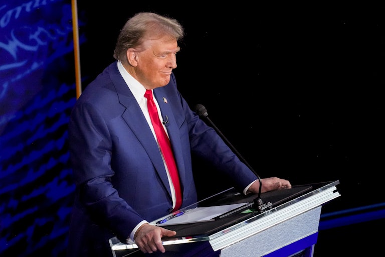 Donald Trump smiles during the debate with Kamala Harris (not picture)
