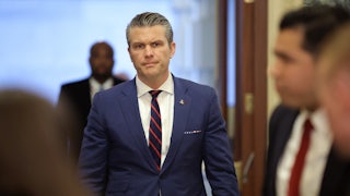 Defense Secretary Pete Hegseth frowns while walking in the Capitol