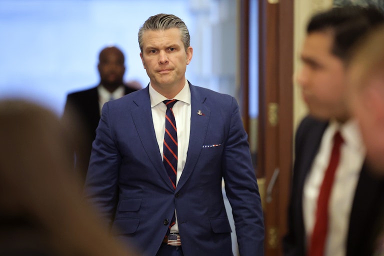 Defense Secretary Pete Hegseth frowns while walking in the Capitol