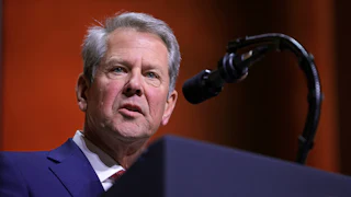 Georgia Governor Brian Kemp speaks at a podium