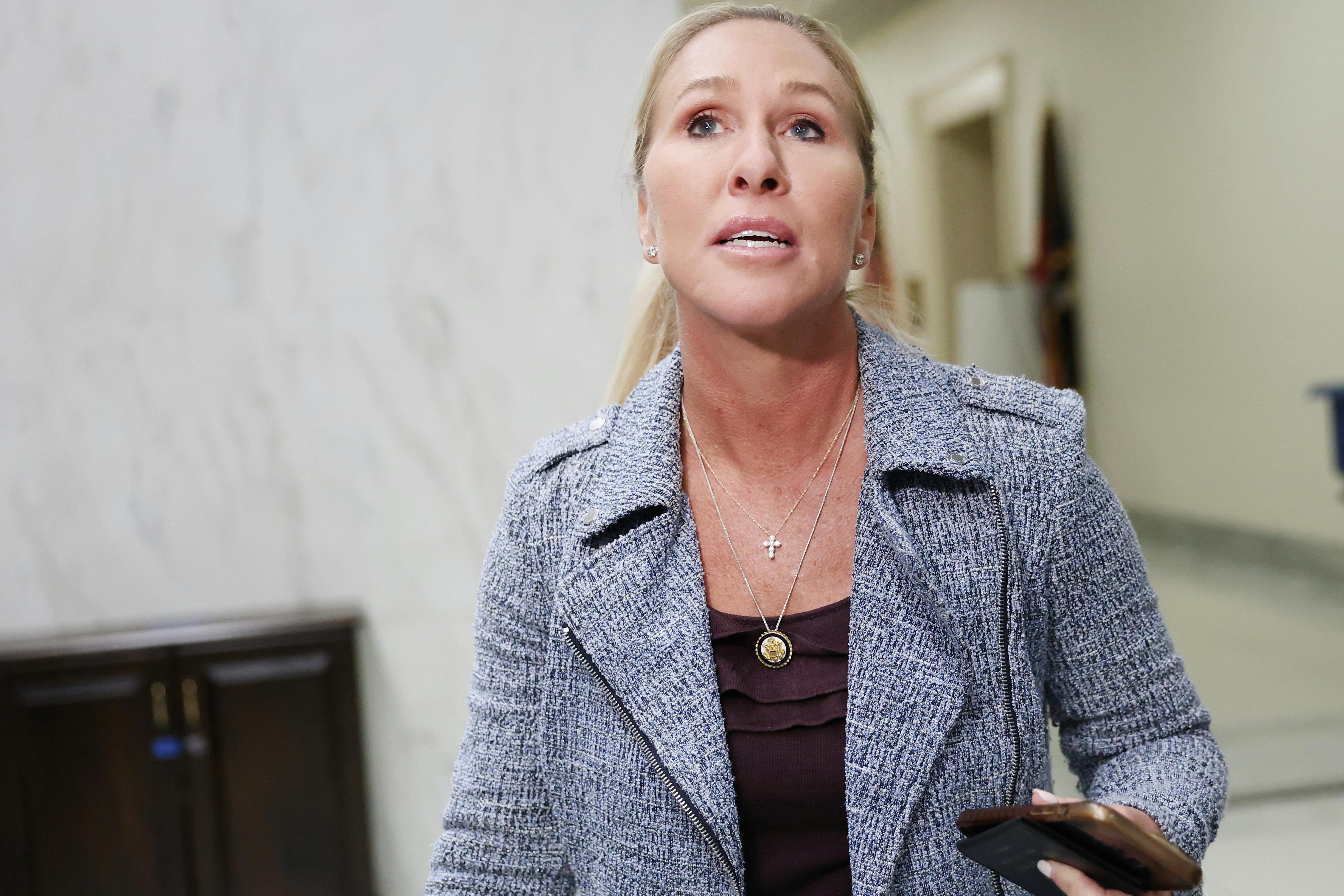 Marjorie Taylor Greene walks through a hallway in the Capitol.