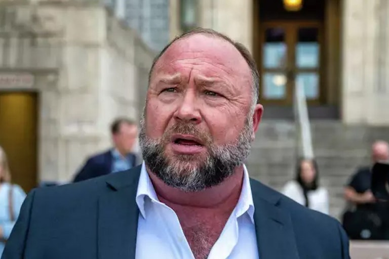 Alex Jones speaks to reporters outside a courthouse in Austin, Texas