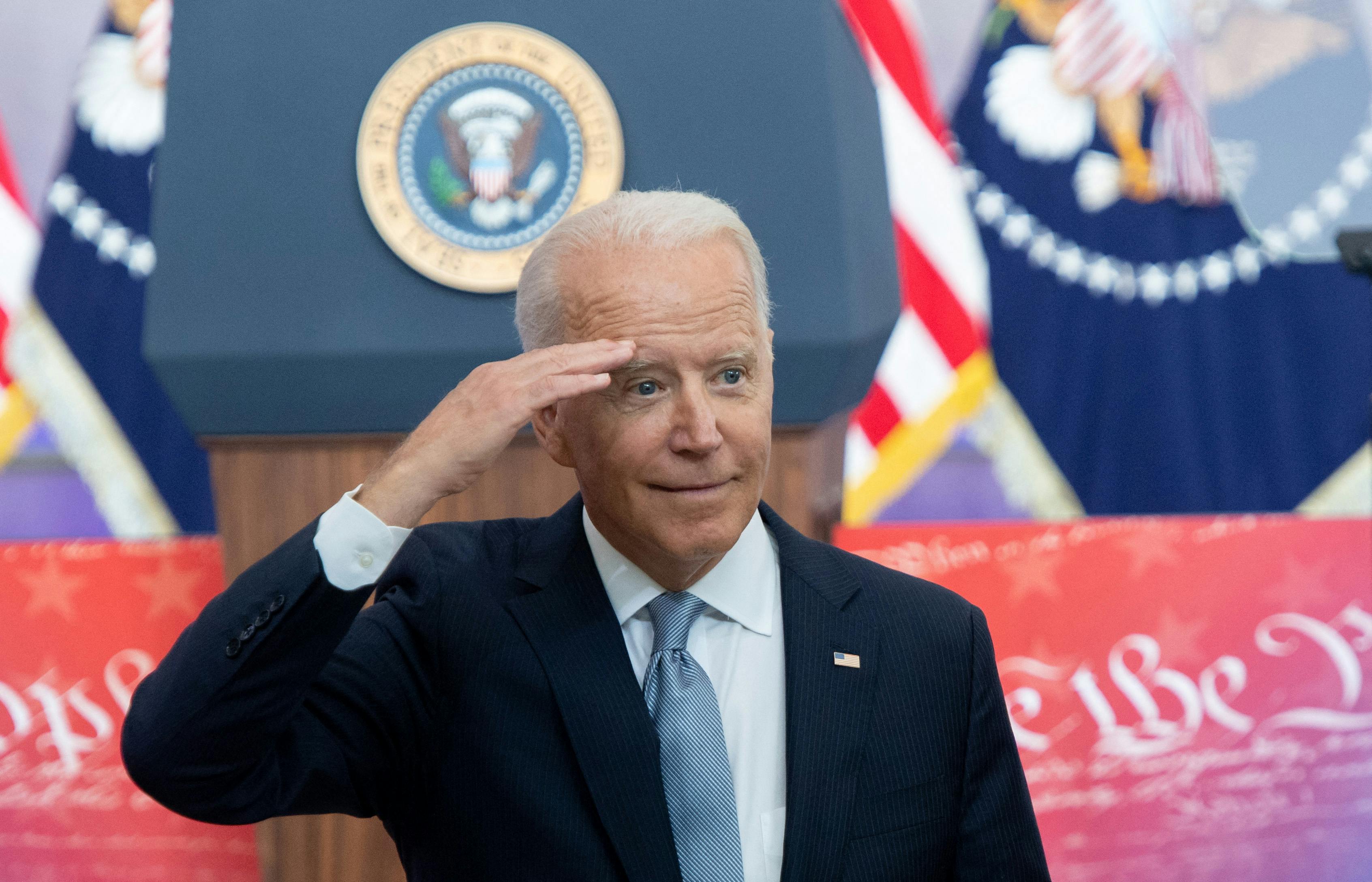 President Biden offers a salute to the crowd during his voting rights speech.