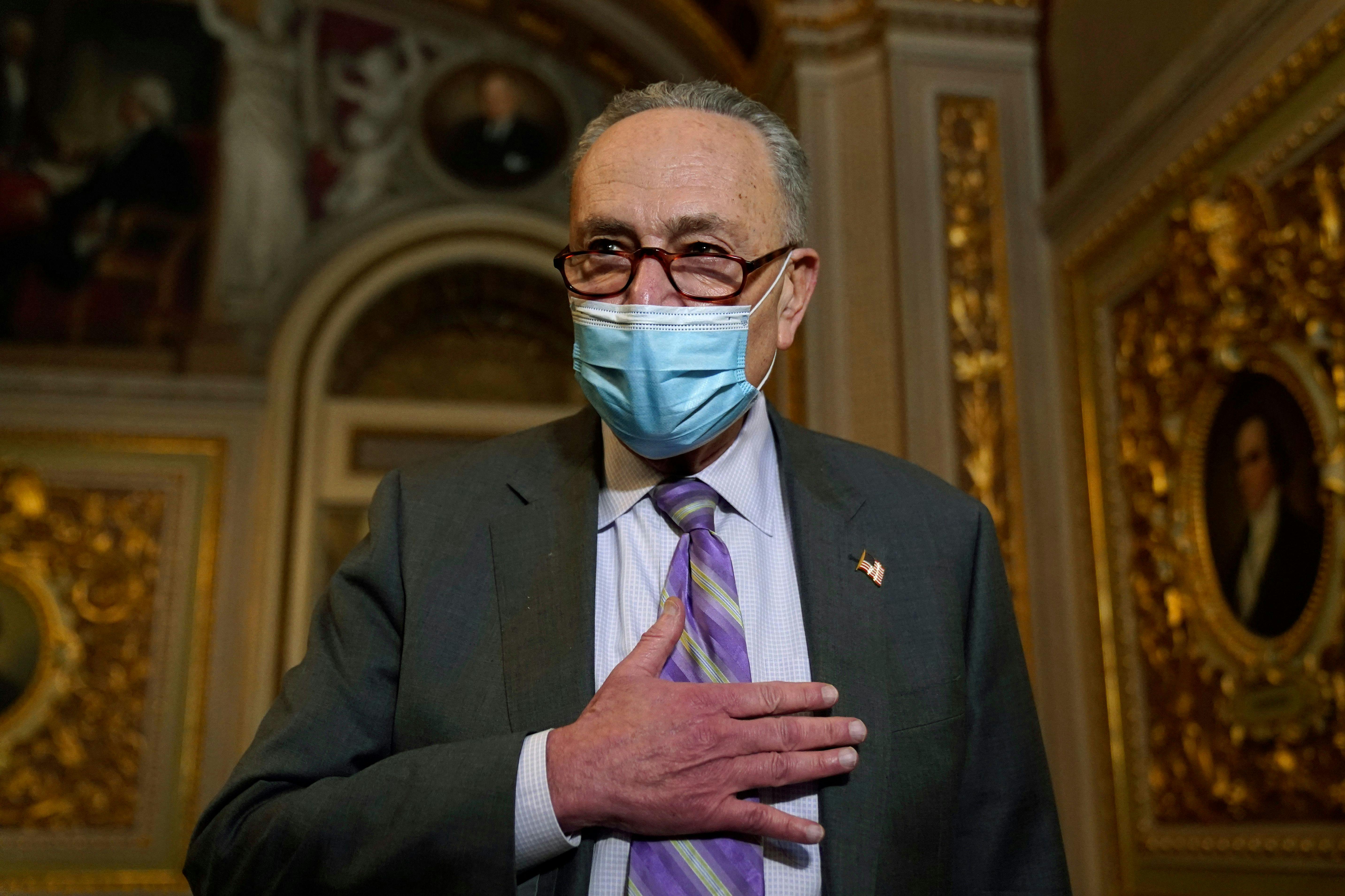 Senate Majority Leader Chuck Schumer gestures as he walks off the Senate floor during Donald Trump's second impeachment trial. 