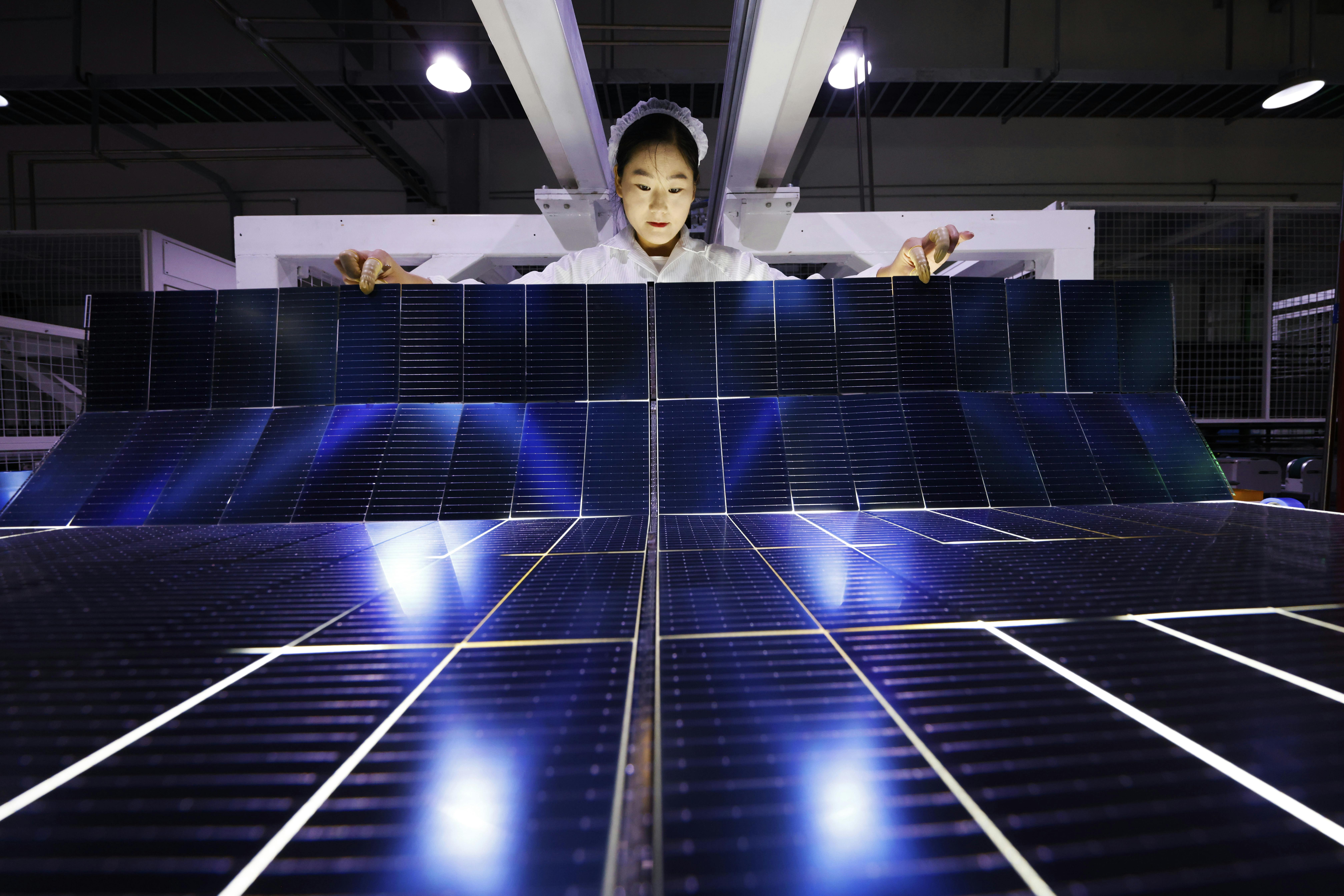 An employee works on the production line of export-bound solar panels at a Chinese factory