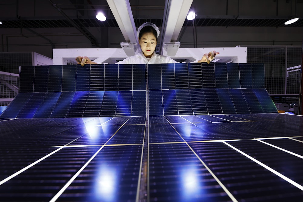 An employee works on the production line of export-bound solar panels at a Chinese factory