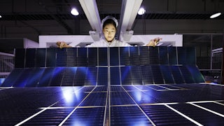 An employee works on the production line of export-bound solar panels at a Chinese factory