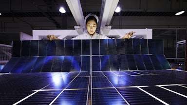An employee works on the production line of export-bound solar panels at a Chinese factory