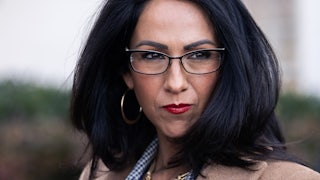 Representative Lauren Boebert walks past reporters outside the Capitol