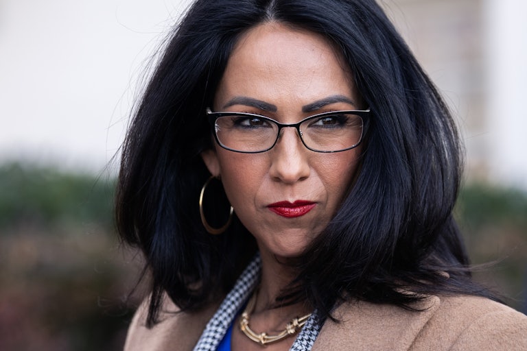 Representative Lauren Boebert walks past reporters outside the Capitol
