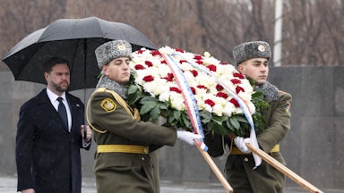 Vice President JD Vance carries an umbrella and walks behind two soldiers carrying a large wreath at the Armenian Genocide Memorial in Yerevan, Armenia