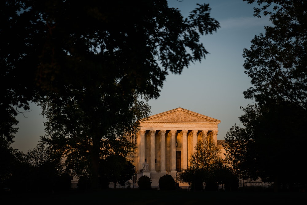 The Supreme Court of the United States sits in evening light.