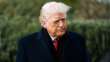 Donald Trump purses his lips while standing outside the White House