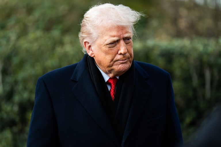 Donald Trump purses his lips while standing outside the White House