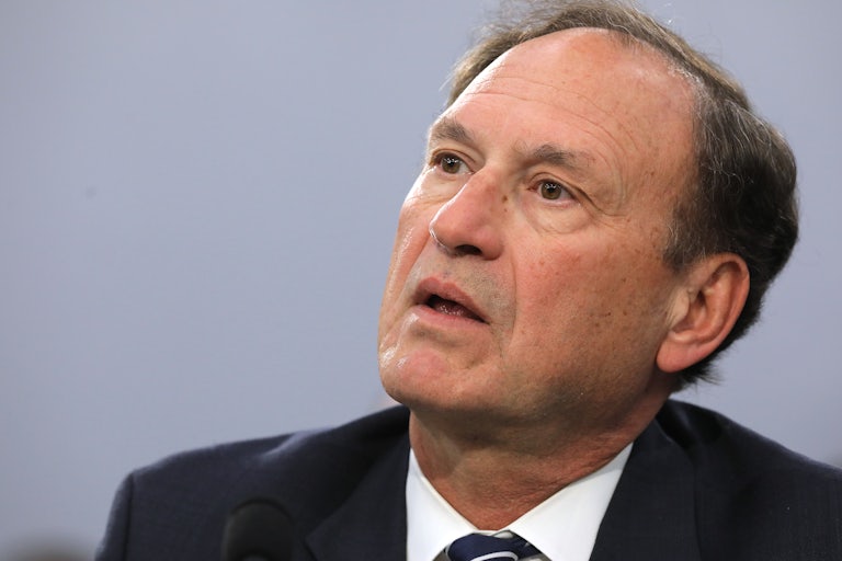 Samuel Alito stares off into the distance with his mouth open
