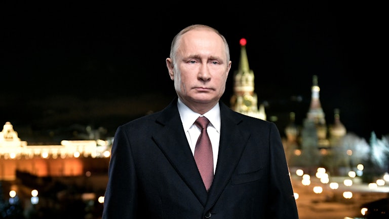 Russian president Vladimir Putin stands as Red Square looms behind him.