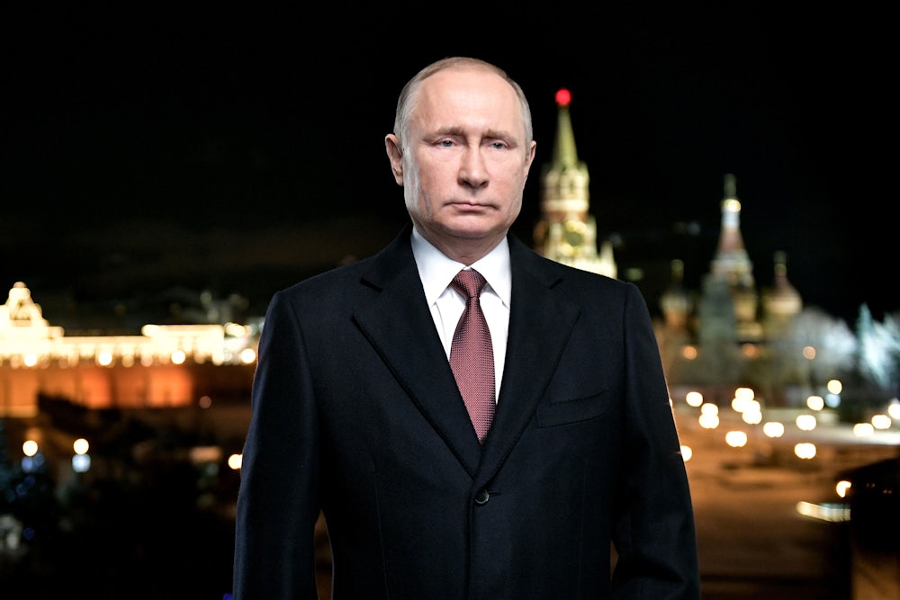 Russian president Vladimir Putin stands as Red Square looms behind him.