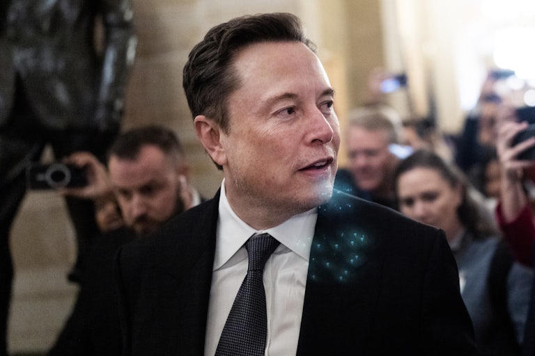 Elon Musk looks to the side while walking in the Capitol