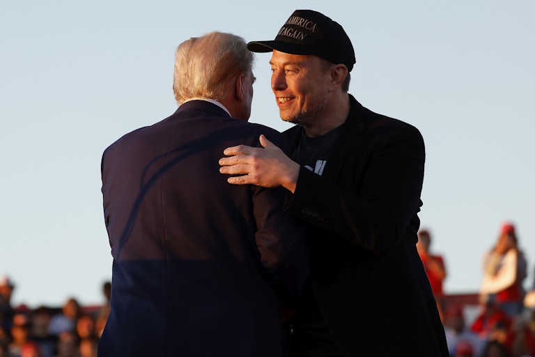 Elon Musk greets Donald Trump with a pat on the back