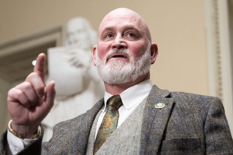 Representative Derrick Orden speaks in the Capitol while raising an index finger for emphasis.