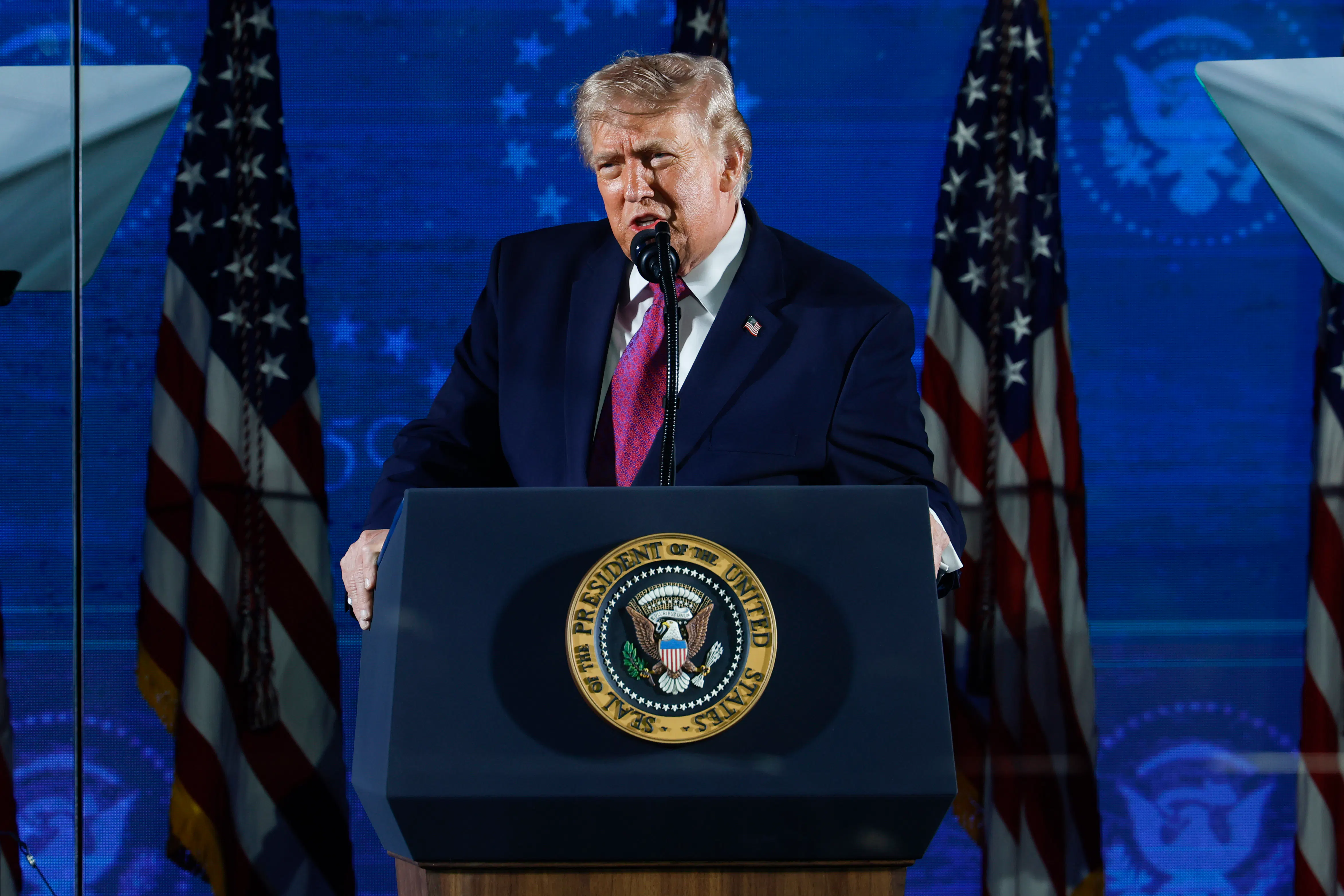 Donald Trump speaking at a podium
