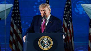 Donald Trump speaking at a podium
