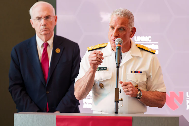 Brian Christine speaks into a microphone at a podium